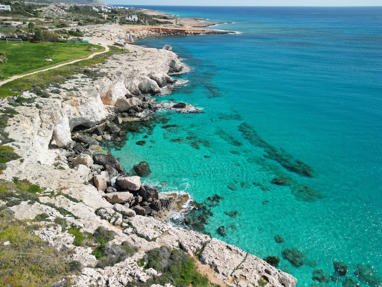 services-03 Stunning aerial photo of Ayia Napa's rocky coast with turquoise sea in Cyprus.