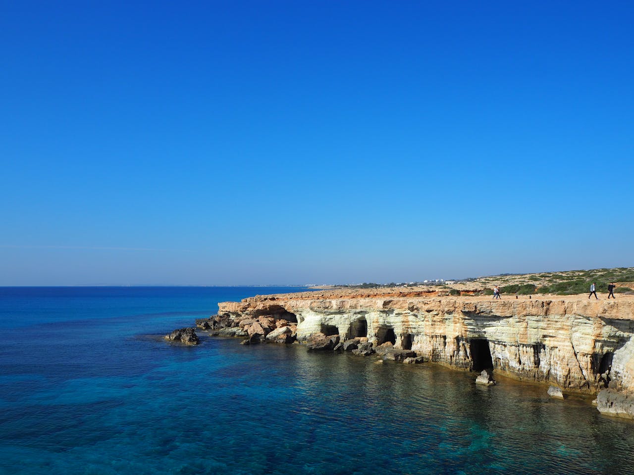 Stunning view of sea caves and clear blue waters in Cyprus along the coast.